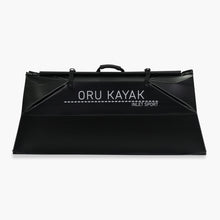 Folded white Oru Kayak Inlet Sport model in black in box form.