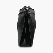 Side folded white Oru Kayak Inlet Sport model in black in box form.