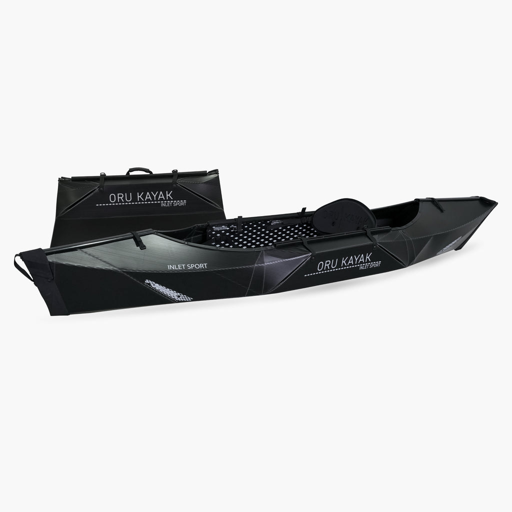 Side view of the Oru Kayak Inlet Sport model in black, shown fully assembled in front of its compact folded box form.