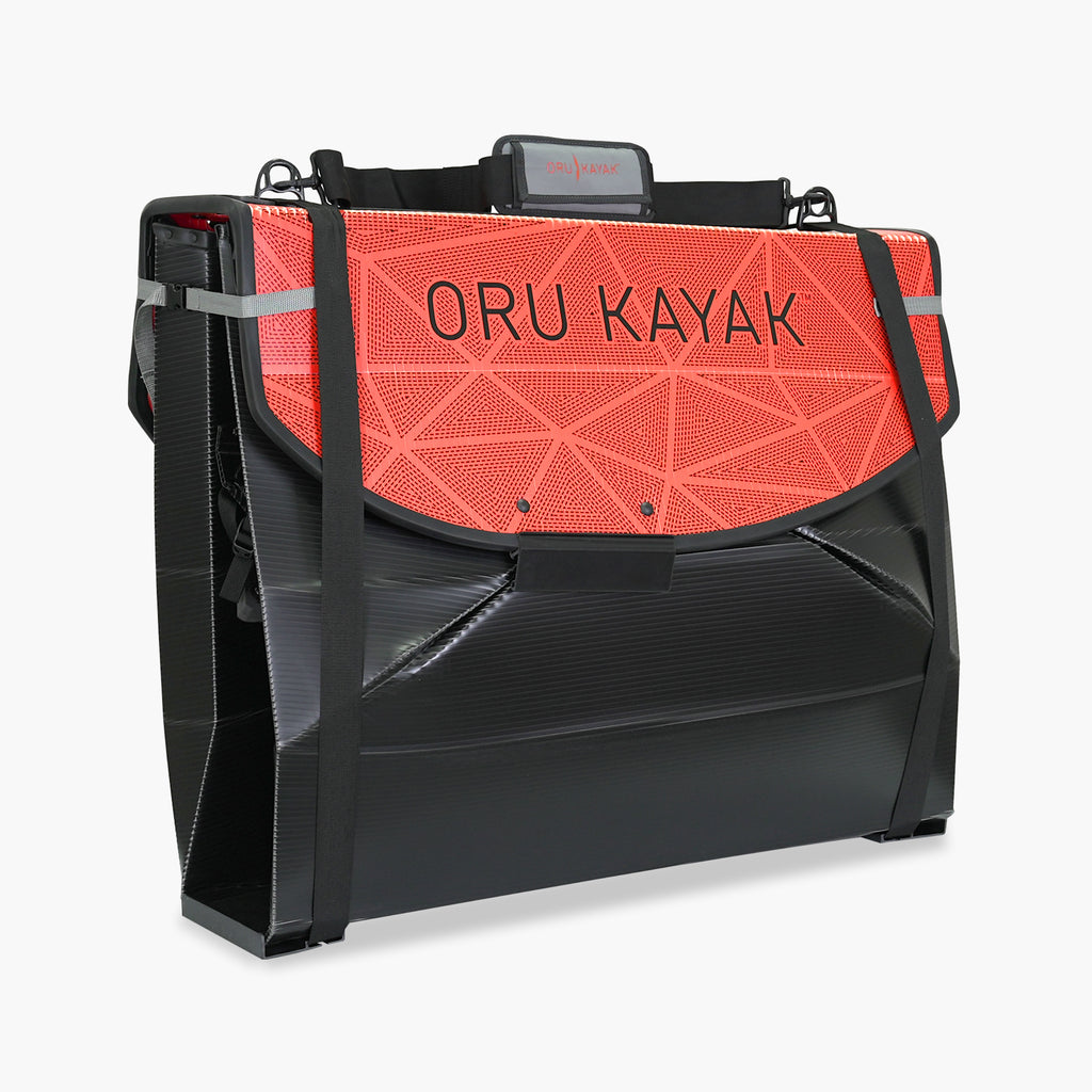 Folded white Oru Kayak Bay model in black in box form.