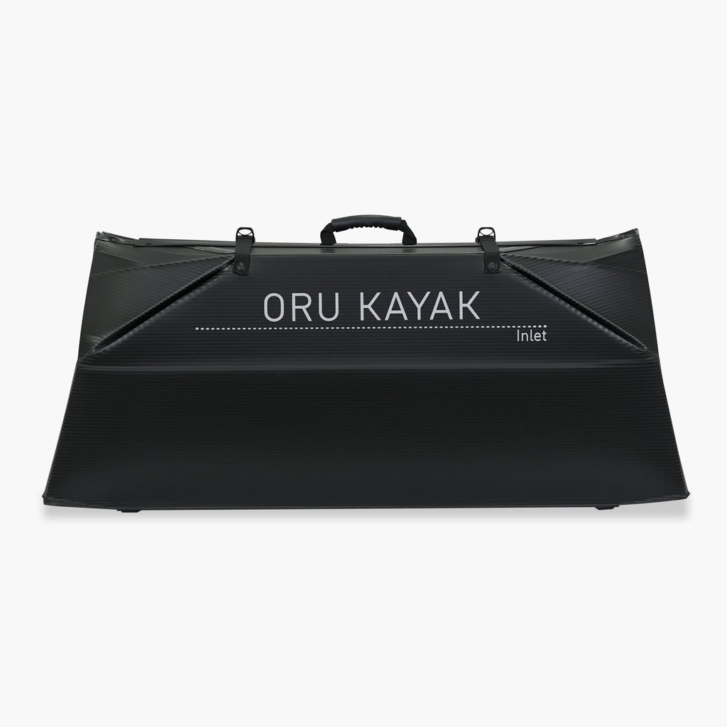 Folded white Oru Kayak Inlet model in black in box form.