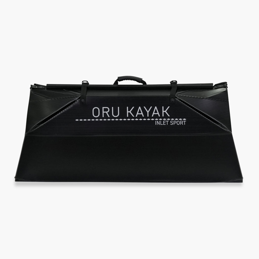 Folded white Oru Kayak Inlet Sport model in black in box form.