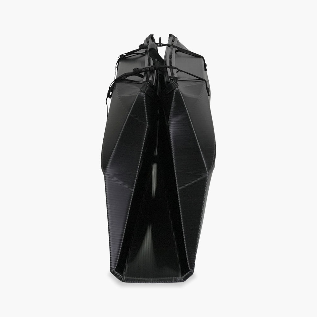 Side folded white Oru Kayak Inlet Sport model in black in box form.