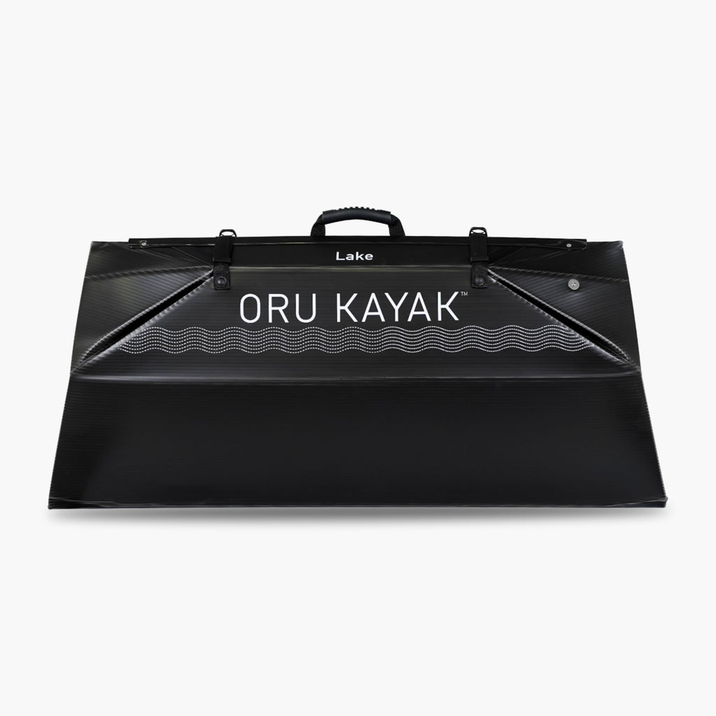 Folded white Oru Kayak Lake Sport model in black in box form.